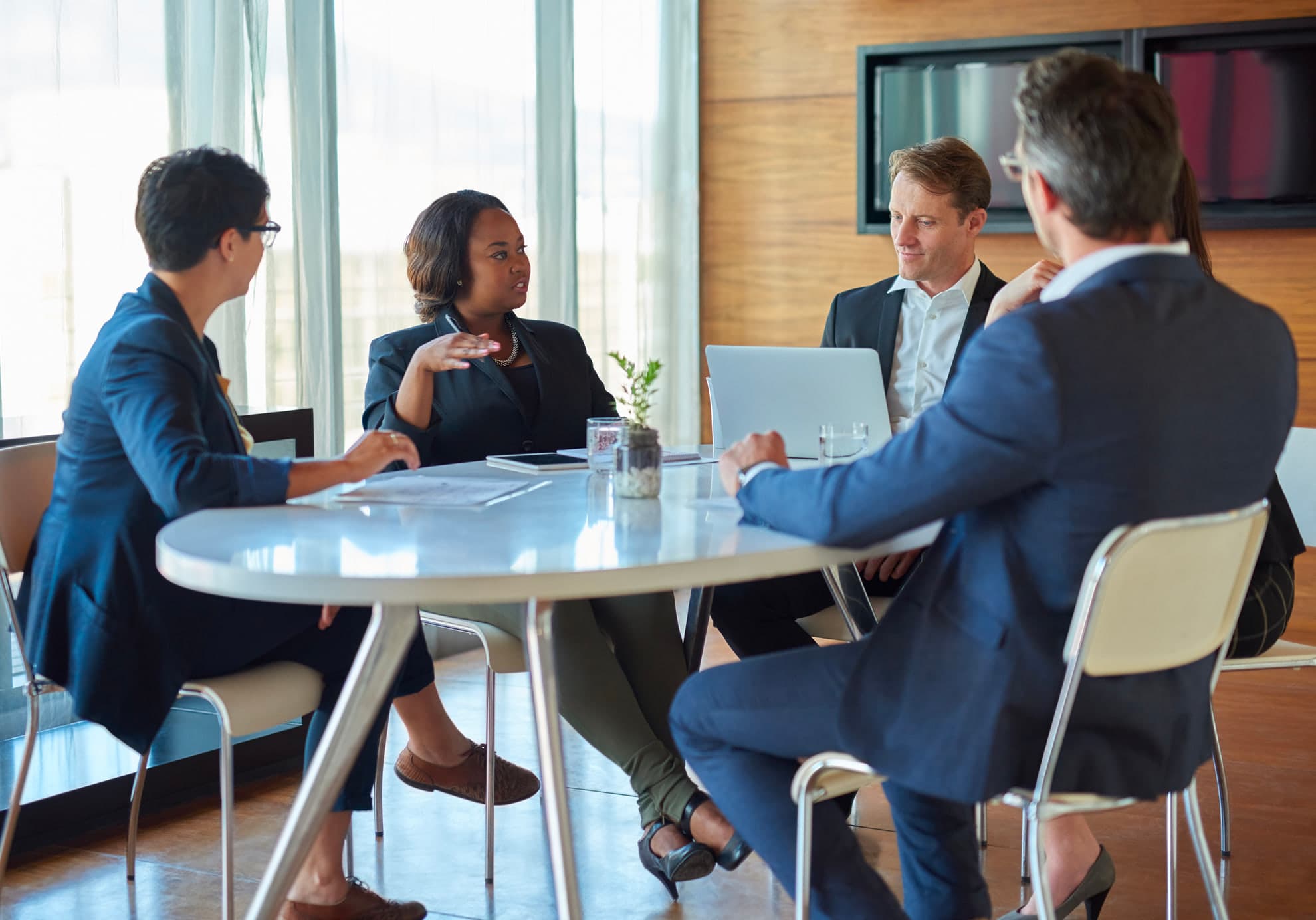 Business leaders in discussion around a meeting table