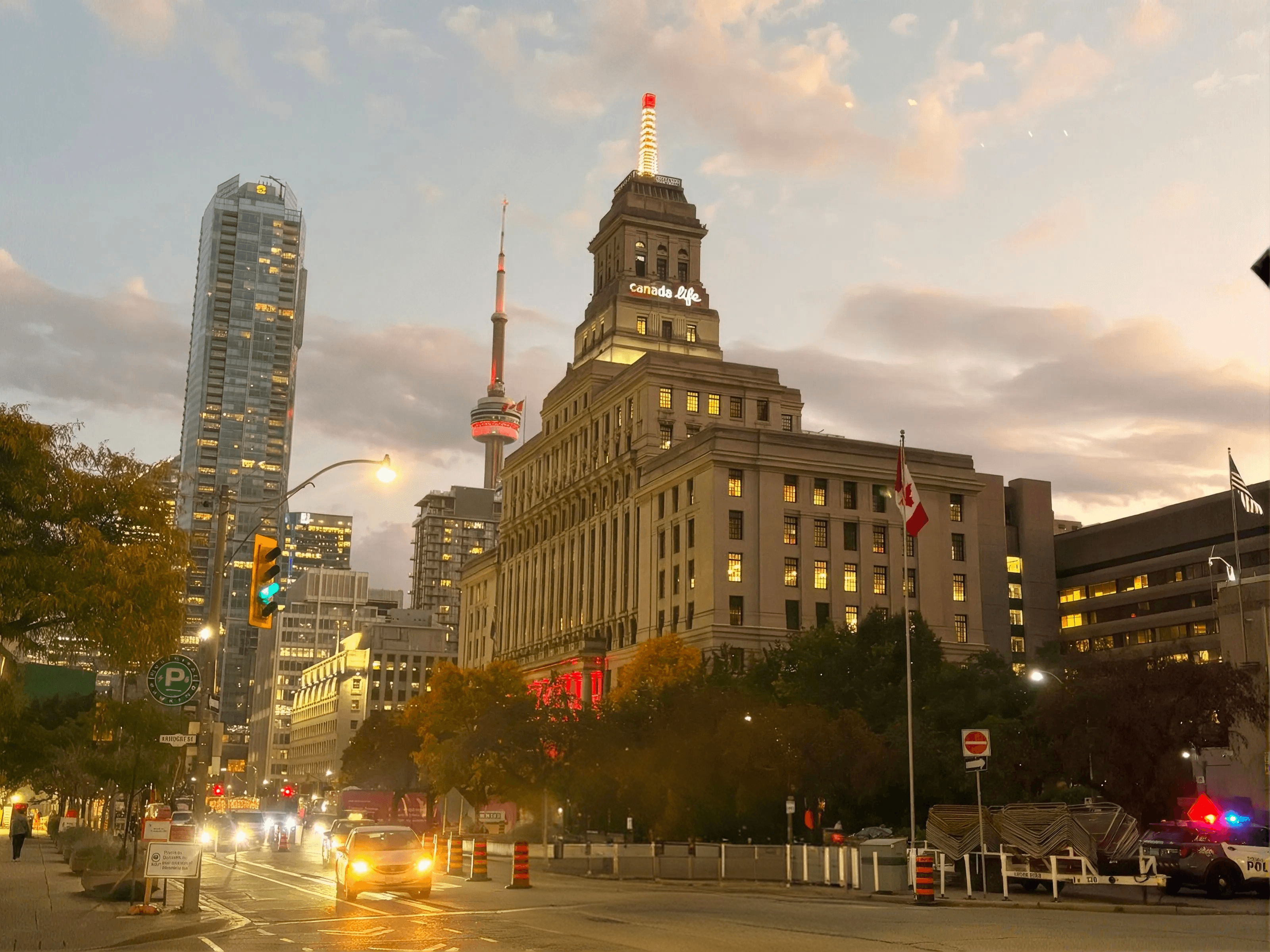 Canadian flag flying in front of the Toronto skyline