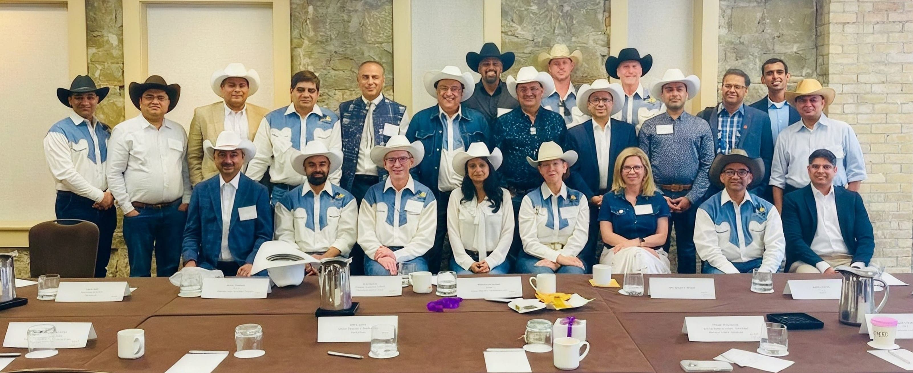 Delegates in cowboy hats gathered for a group photo at the India Roundtable during Calgary Stampede